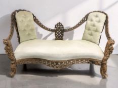 An Anglo-Indian carved hardwood two seater salon settee with lion mask armrests, width 163 cm.