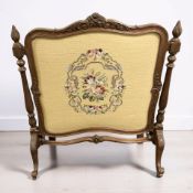 A carved oak tapestry fire screen, height 80 cm.