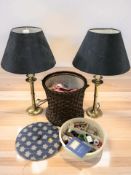 A pair of brass table lamps and a circular wicker work box.