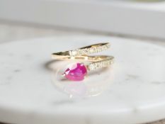 A 14ct rose gold diamond and ruby 'snake' ring, size N. CONDITION REPORT: 3.