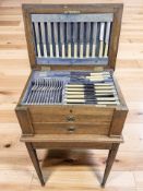 An oak cased canteen on stand of Walker & Hall EPNS cutlery, width 50 cm.