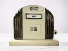 A French Art Deco enameled metal desk calendar, width 14 cm.