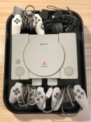 A Sony Playstation 1 console, model SCPH-1002, three controllers and leads.
