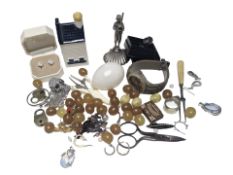 A small box of collectibles including a white metal figure of a bagpipe player,