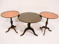 A pair of reproduction mahogany and tooled leather inset wine tables, diameter 44 cm,