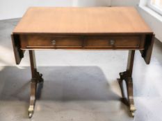 A reproduction mahogany drop leaf sofa table, extended length 140 cm.