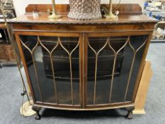 A 1920's mahogany bow front double door display cabinet, width 122 cm.