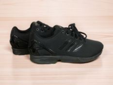 An unworn pair of Adidas Torsion running shoes, size 10.5.