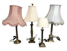 Three brass table lamps and a gilt plaster lamp.