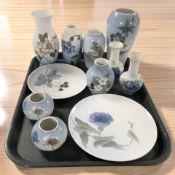 A group of Royal Copenhagen porcelain vases and plates.