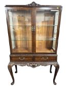 A reproduction mahogany glazed double door display cabinet on cabriole legs,