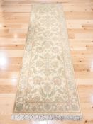 An Indian floral woolen runner, 287 cm x 84 cm.