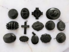 A collection of fourteen pieces of jet jewellery, pendants, mourning brooches, crucifix,