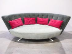 A contemporary Barker & Stonehouse curved settee in buttoned grey upholstery, length 230 cm.