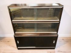 A reproduction mahogany sliding glass door bookcase, 91 cm x 26 cm x 102 cm.