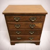 A 20th century walnut four drawer chest in the Georgian style, width 56 cm.