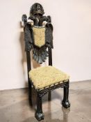 A reproduction carved and stained pine hall chair with Bavarian-style twin eagle backrest,
