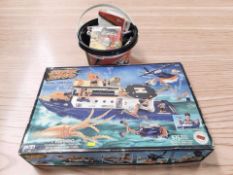 A Creature Seekers naval command modelling kit and a bucket containing a quantity of Meccano.
