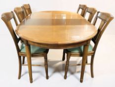 A reproduction cherry wood extending dining table with two leaves, overall 203 cm x 116 cm x 74 cm,