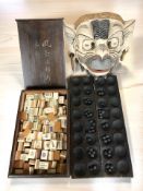A Balinese painted and gilt papier mache demon mask, a mahjong set in hardwood box,