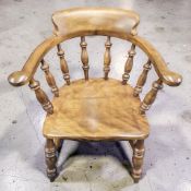 A beech spindle back elbow chair, width 66 cm.