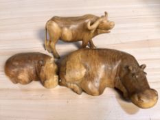 Two carved hardwood hippo figures, largest 42 cm long, and a further buffalo.