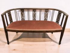 An Edwardian inlaid mahogany two seater salon settee, length 124 cm.