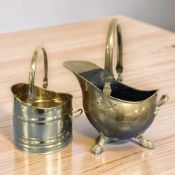 A Victorian brass coal bucket with swing handle and a reproduction example.