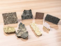 A group of decorative carved wooden printing blocks, largest 19 cm wide.