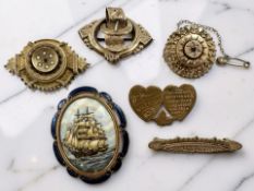 Six yellow metal brooches in varying styles : Belt and Buckle, Mizpah, Ship Cameo, etc, no marks,