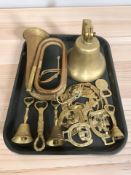 A brass ship's style bell, horse brasses, copper and brass bugle, etc.