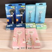 Ten various packs of Gillette razors and blades.
