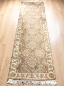 An Indian floral woolen runner, 281 cm x 86 cm.