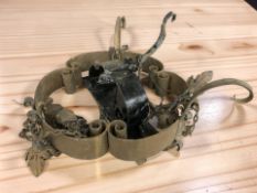 A wrought metal chandelier and a further wall bracket.