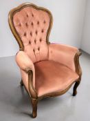 A reproduction armchair in the Victorian style, upholstered in pink draylon,