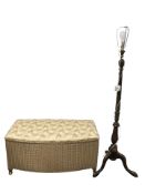 A gilt loom storage ottoman and a standard lamp.
