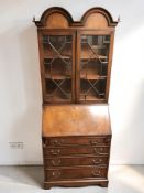 A reproduction walnut bureau bookcase in the Queen Anne style, width 76 cm.