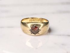An 18ct gold gypsy-set garnet ring, size L CONDITION REPORT: 3.