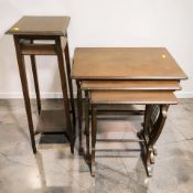 A mahogany nest of three tables and a plant stand.