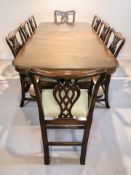 A reproduction mahogany extending twin pedestal dining table with leaf,