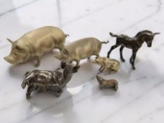 Three brass figures of pigs, longest 21cm, two similar resin figures,