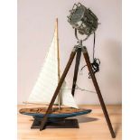 A vintage-style chrome spot light on tripod, height 93 cm, together with a model yacht.