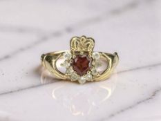 A 9ct gold garnet Claddagh ring, size P CONDITION REPORT: 1.