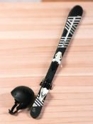 A pair of child's Wedze skis and a skiing helmet.