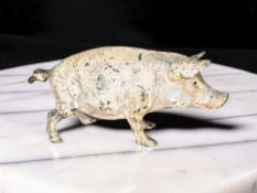 An Austrian cold-painted bronze figure of a pig, circa 1900, stamped Geschutzt, length 6.5cm.