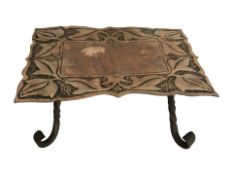 An Arts and Crafts copper and iron trivet, the copper top with leaf decoration,