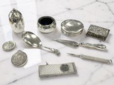 A group of silver comprising a circular compact, a pepperette and matching salt, a matchbox cover,