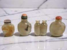 Four Chinese agate snuff or scent bottles, one carved in relief depicting a leaping fish,