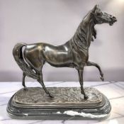 A reproduction patinated bronze figure of a cantering horse, on stepped marble plinth,