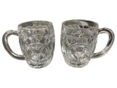 A pair of glass 'Victory' mugs,